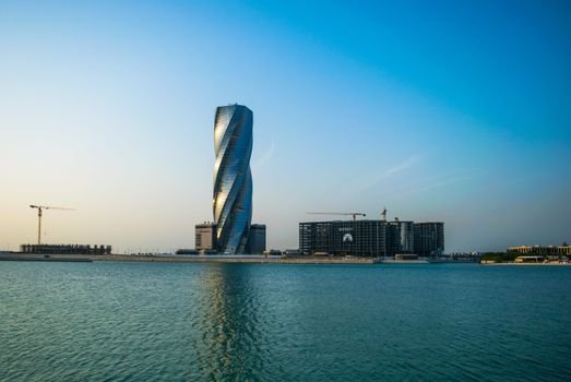 Stunning view of the United Tower in Bahrain's skyline by the water.