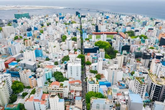 A breathtaking aerial view of Malé, Maldives, showcasing the colorful urban cityscape by the sea.