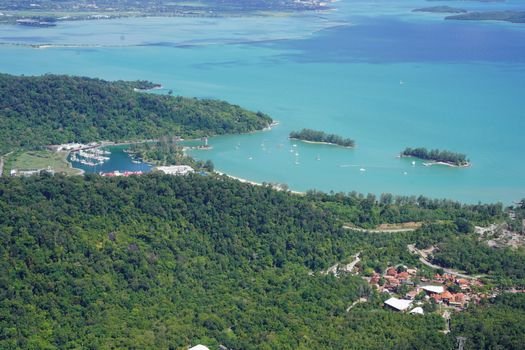 Scenic aerial view of Langkawi's coastline with vibrant greenery and marinas. Perfect for travel inspiration.