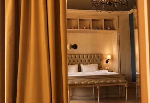 Elegant hotel room in Baku featuring stylish decor, plush bedding, and warm lighting, creating a cozy atmosphere.