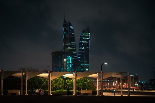 Stunning night view of Bahrain's skyline with illuminated modern towers and cityscape.