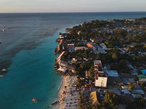 Stunning aerial photograph of Nungwi Beach, Zanzibar capturing the serene coastline at sunset.