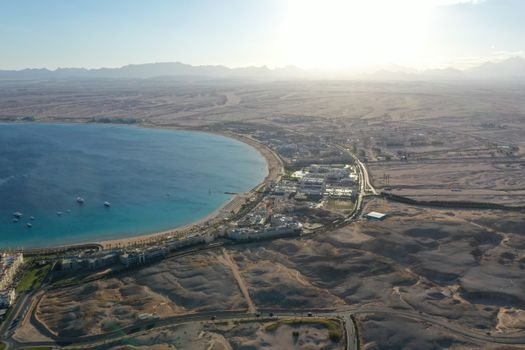 Stunning drone shot of Hurghada's coastline and desert panorama during sunset.