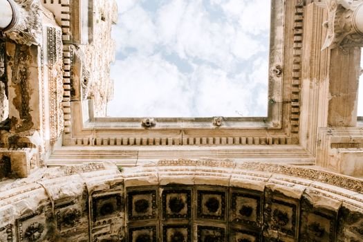 Looking up at the intricate architectural details of ancient ruins against the sky.