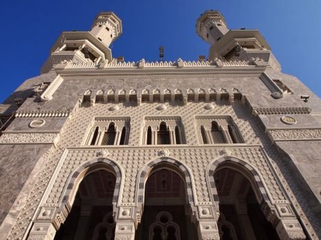 Dramatic upward shot of the Grand Mosque's ornate exterior showcasing exquisite Islamic architecture.